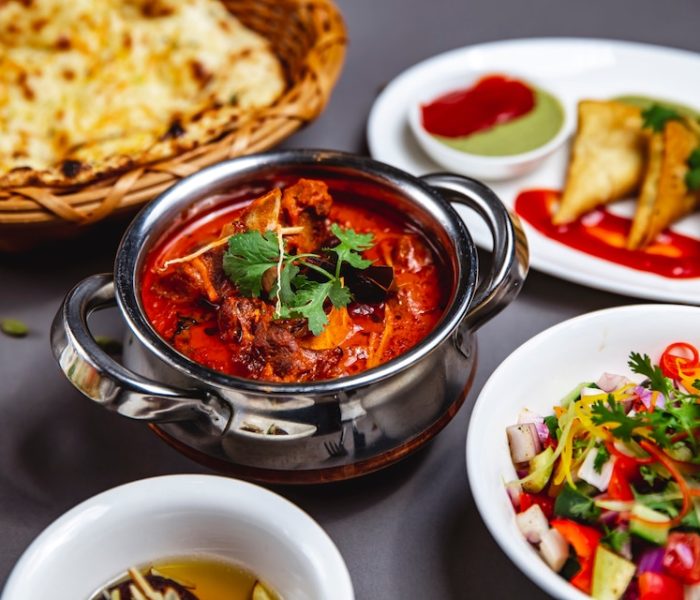 [freepicdownloader.com]-side-lamb-ragout-with-fried-onion-carrot-tomato-sauce-greens-vegetable-salad-table-large